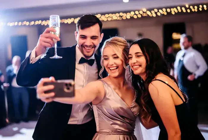 Wedding guests recording messages on their phones