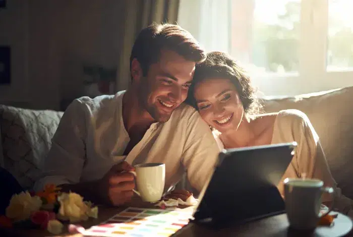 Couple creating their digital wedding guestbook